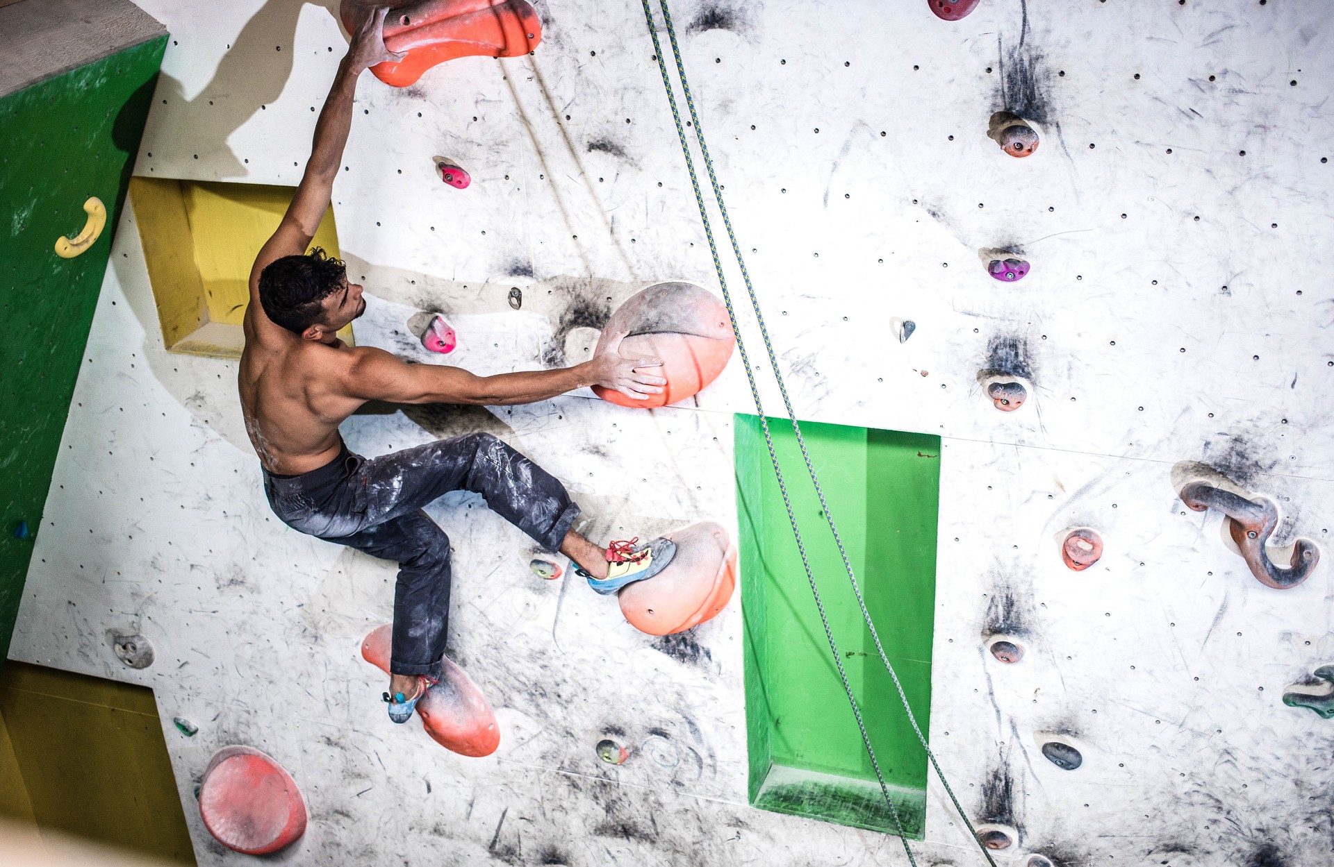 Athlete Climbing in a Bouldering Gym